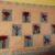 Children’s fall tree artwork with red painted leaves and brown paper trunks displayed on a classroom bulletin board.