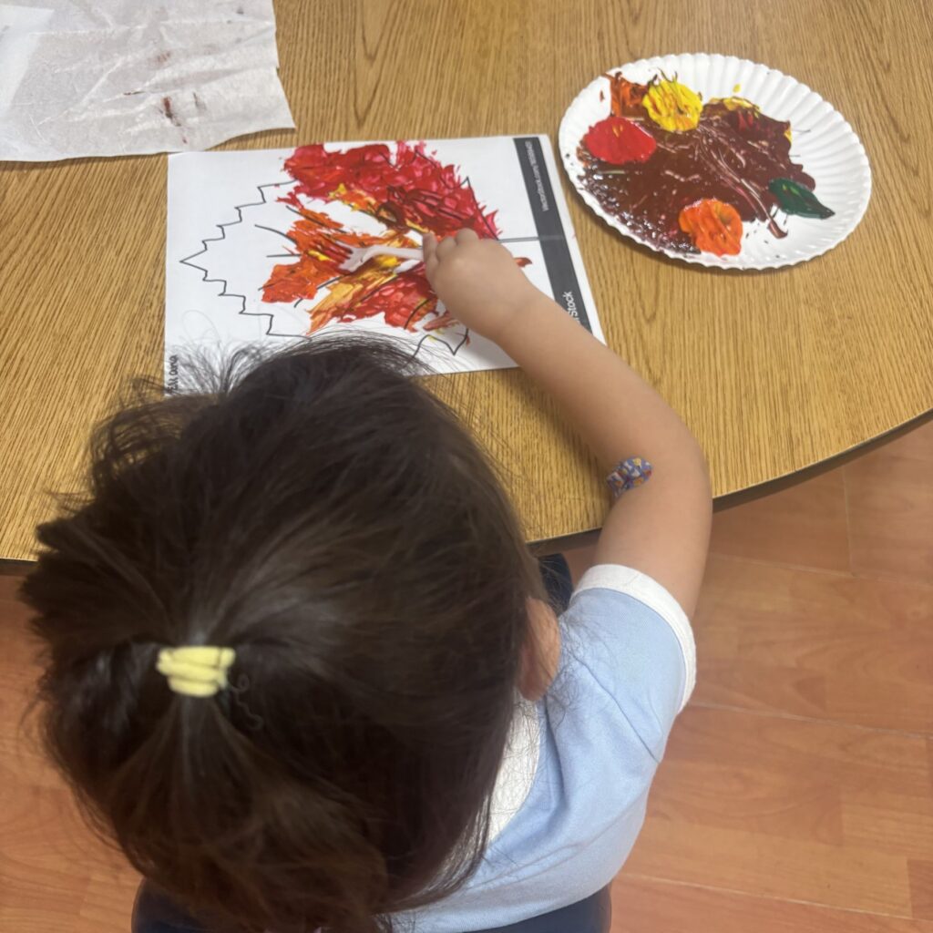 arlc-program-child-stamping-autumn-tree-painting-12 Child stamping a painted autumn tree